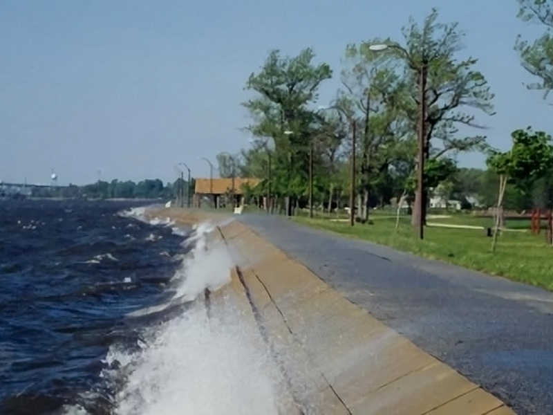 paved road next to large body of water