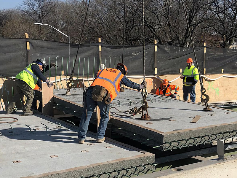 construction workers installing super-slab