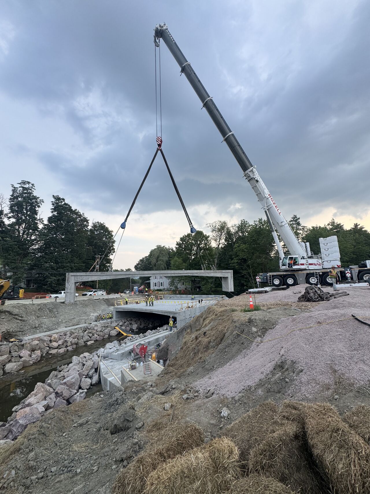Crews installing precast rigid frame bridge components