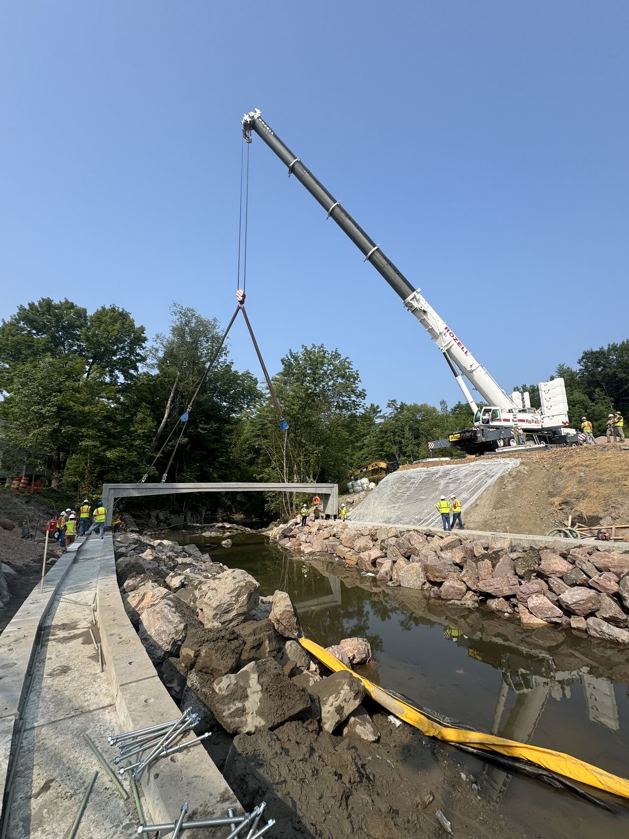 Crews installing precast rigid frame bridge components