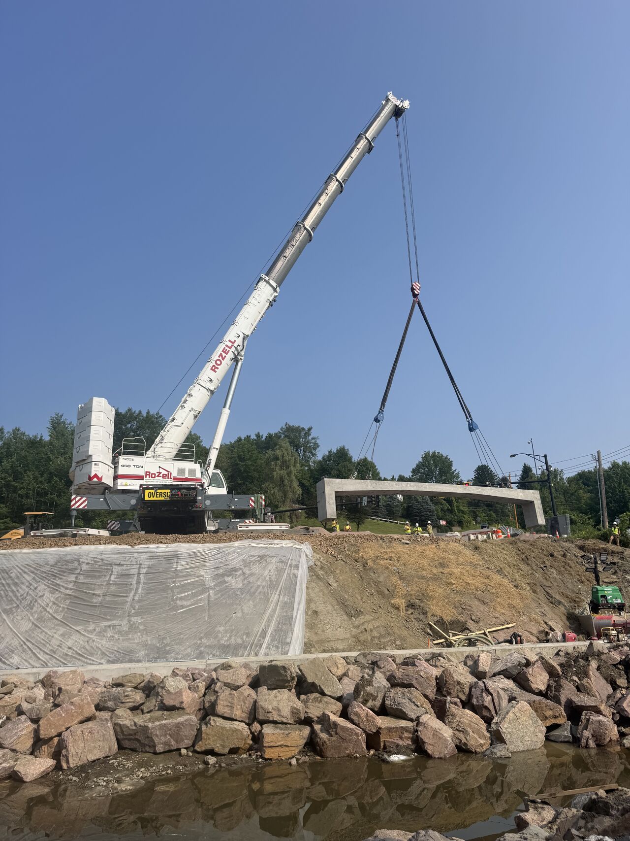 Crews installing precast rigid frame bridge components