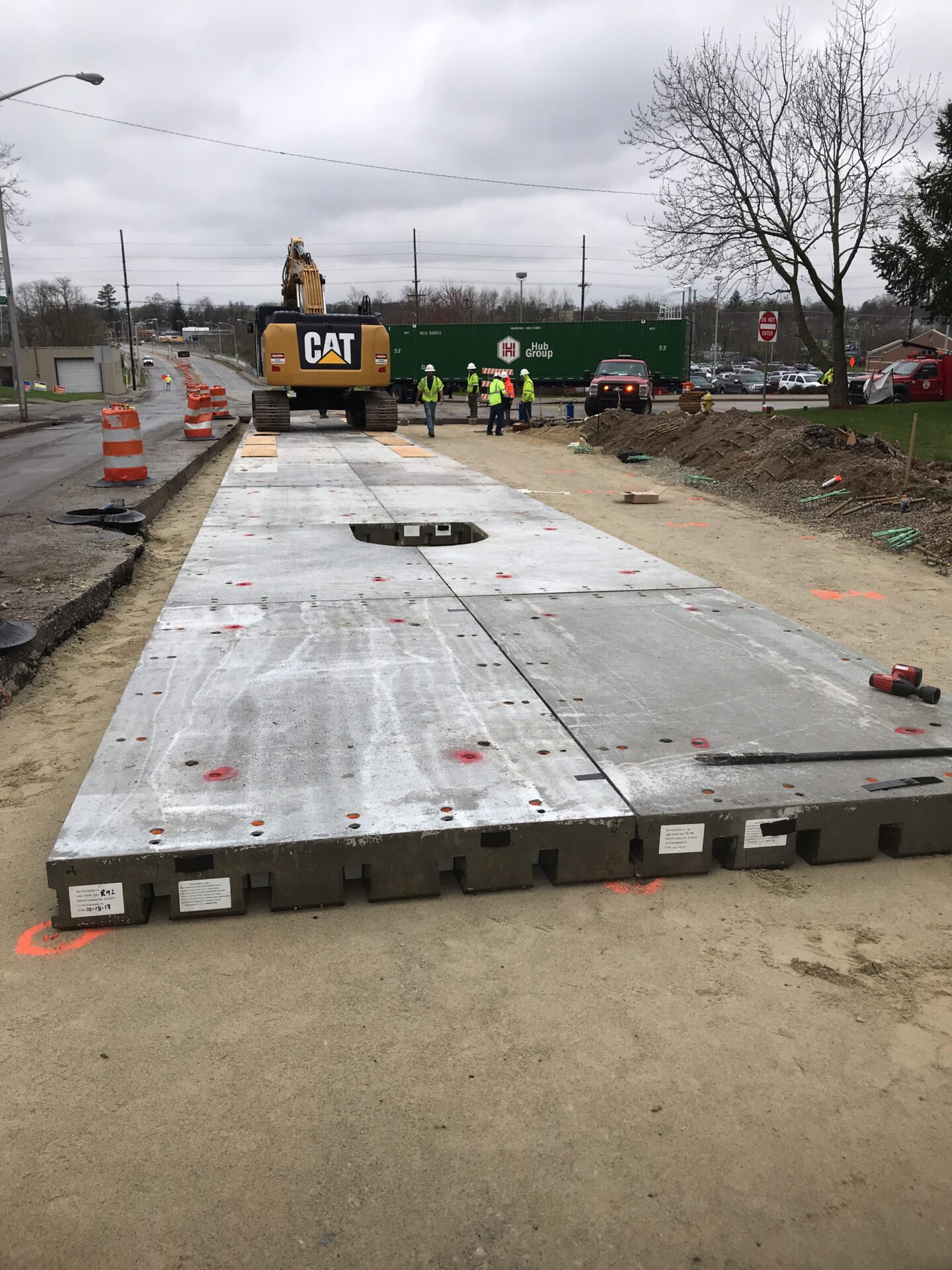 Crews install removable precast concrete pavement panels
