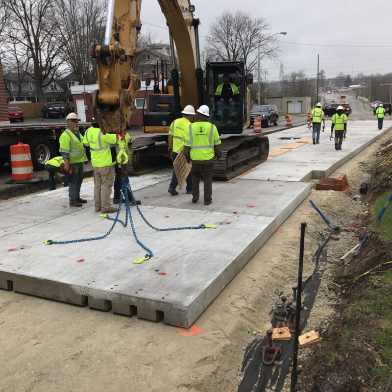 Crews install removable precast concrete pavement panels
