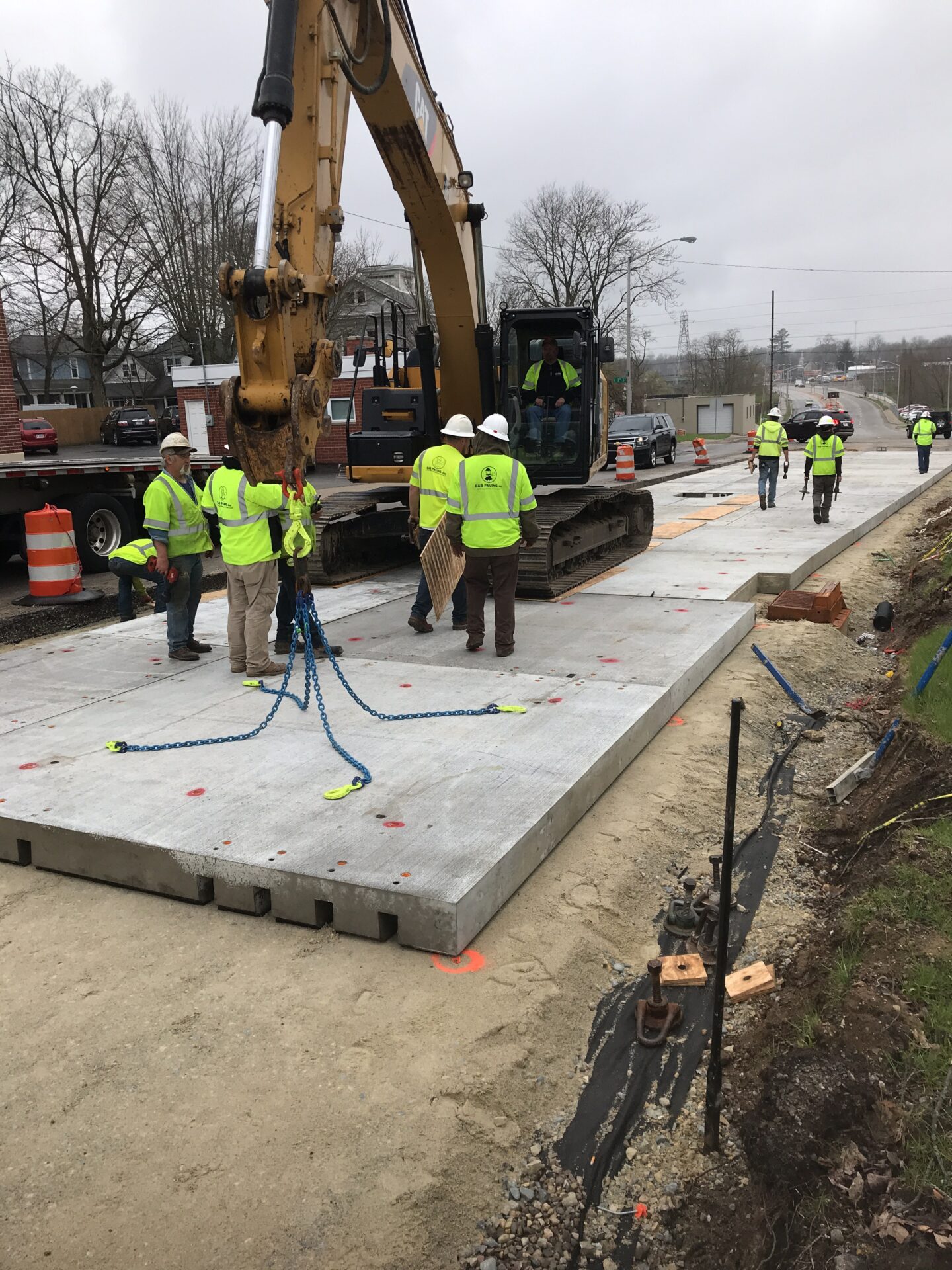 Crews install removable precast concrete pavement panels